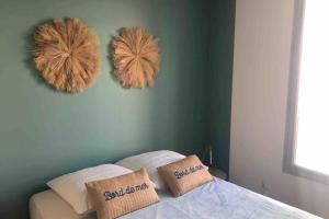 a bedroom with two furry pillows on a bed at Centre, lumineux appartement T3 6 Pers Terrasse wifi pkg clim in Antibes