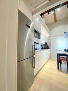 a stainless steel refrigerator in a kitchen with a table at San Juan Centro Histórico in Burgos