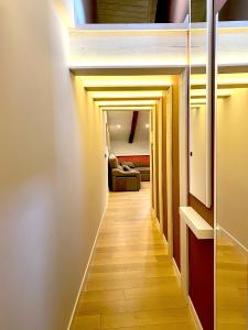 a hallway leading to a living room with a couch at San Juan Centro Histórico in Burgos +3 photos