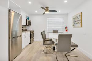 a kitchen with a table and chairs and a refrigerator at ULTRA joyful apartment perfect for families in Hollywood