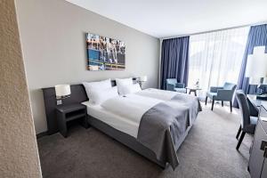 Postel nebo postele na pokoji v ubytování ATLANTIC Hotel Vegesack