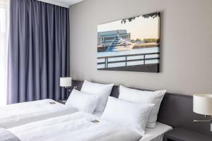 Postel nebo postele na pokoji v ubytování ATLANTIC Hotel Vegesack