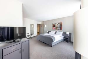 TV a/nebo společenská místnost v ubytování ATLANTIC Hotel Vegesack