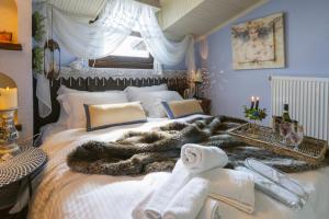 a bed with a blanket and towels on it at selikalpakishouse in Seli