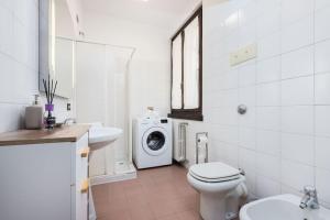 a bathroom with a washing machine and a washer and dryer at Borgo Palazzo - Vista Città Alta e Terrazza in Bergamo +24 photos
