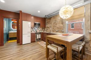 a kitchen with a wooden table and a dining room at Lavish Loft on Main St - Walk to Stn Mtn Park! in Stone Mountain