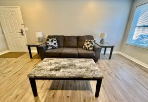 a living room with a couch and two tables at Aksarben View Gem-Near UNO in Omaha