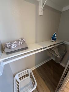 a room with a shelf with a basket on it at Aksarben View Gem-Near UNO in Omaha