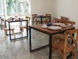 a dining room with wooden tables and chairs at Estancia Monraz in Guadalajara