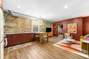 a kitchen with a table and a living room at Lavish Loft on Main St - Walk to Stn Mtn Park! in Stone Mountain