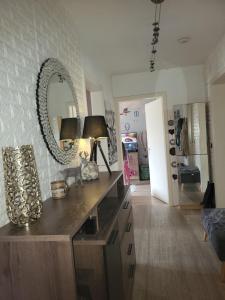 a room with a mirror on the wall and a table at Apartment mit 3 Zimmer in Wolfratshausen