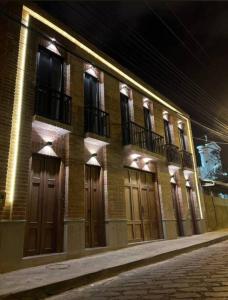 a building with wooden doors on a street at night at Apartamento con encanto cerca del centro de Cuenca in Cuenca