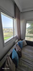 a couch in a room with a large window at Bizerte Résidence soltana RDC vue mer in Bizerte