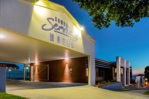 a sun sierra hotel sign on the side of a building at Cowra Services Club Motel in Cowra