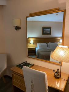 Uma cama ou camas num quarto em Hotel Lusitano