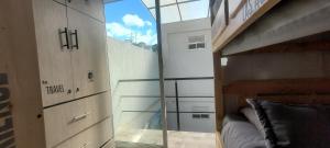 a bedroom with a glass door and a bunk bed at Las Aguas Inner Experience in Bogotá +59 photos