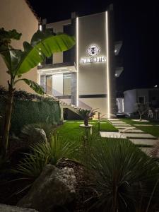 a building with a sign that reads walks hotel at Twins Hotel Vlore in Vlorë