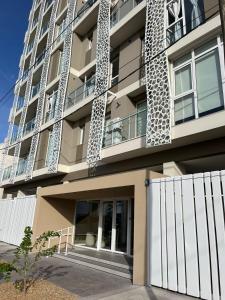 a building with a white fence in front of it at Alquiler depto olavarria in Olavarría