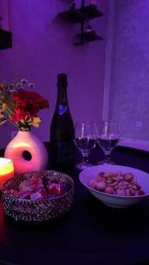 a table with wine glasses and a plate of food at Lescapade in Luxeuil-les-Bains +7 photos