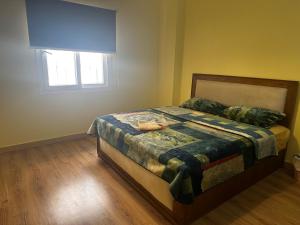 a bedroom with a bed and a window at Hotel Apartment art city compound in Cairo