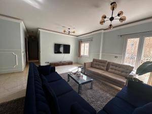 a living room with a couch and a tv at Hotel Apartment art city compound in Cairo