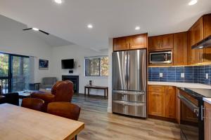 a kitchen with wooden cabinets and a stainless steel refrigerator at Red Pine By Park City Vacations in Park City