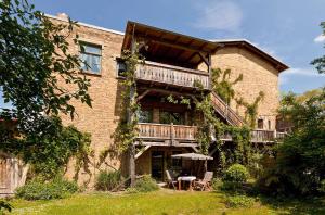a large brick building with a balcony and a table at Ferienwohnung Lilie mit Balkon in einer geschmackvoll sanierten Backsteinmühle in Waren