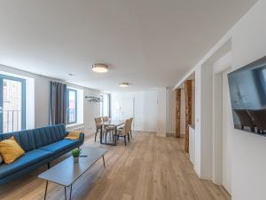 a living room with a blue couch and a table at StadtApartment im Luftkurort Malchow in Malchow