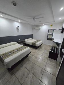 Postel nebo postele na pokoji v ubytování Hotel Raga Inn