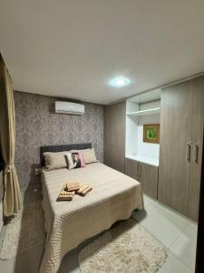 a bedroom with a bed with two towels on it at Duplex Central Rio Grande in Rio Grande