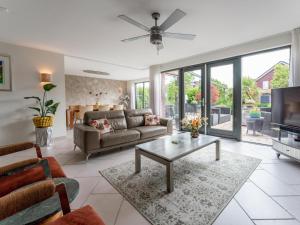 a living room with a couch and a table at Alkmaar aan het Water in Alkmaar