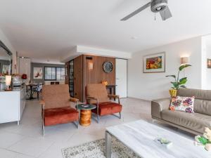 a living room with a couch and chairs and a table at Alkmaar aan het Water in Alkmaar