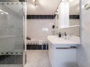 a white bathroom with a sink and a shower at Alkmaar aan het Water in Alkmaar +36 photos