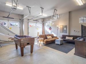a living room with a ping pong table at Suncadia 3 Bdrm Home with Hot Tub + Game Room in Cle Elum