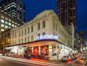 a city street at night with tall buildings at Hotel DeBrett in Auckland