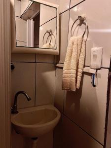 Un baño con lavabo, espejo e inodoro. en Pousada Portobello, en Recife