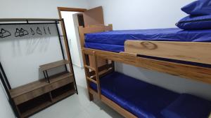 a pair of bunk beds in a room at JARDIM DAS PALMEIRAS II - HOME RESORT in Ubatuba +17 photos
