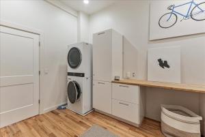 a white laundry room with a washer and dryer at Pioneer Park Splash Pad Close & Pet Friendly in Hurricane