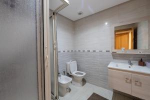a bathroom with a toilet and a sink and a mirror at Charming City Getaway in Marrakech