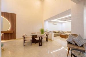 a living room with a table and chairs and a couch at Charming City Getaway in Marrakech +10 photos