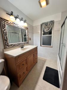 a bathroom with a sink and a mirror at Holyoke House Oasis - Fast Wifi, Spacious, Quiet Neighborhood in Holyoke