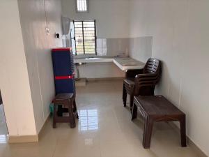 a kitchen with a table and chairs in a room at SRIRAM HOMESTAY 01 KM to SRI RAM MANDIR in Ayodhya
