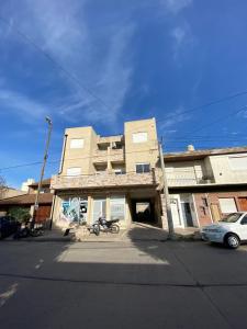 a building with a motorcycle parked in front of it at Namante in Balcarce