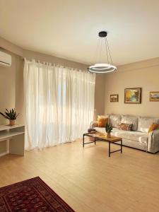 a living room with a couch and a table at Smart Rent Apartment in Tirana