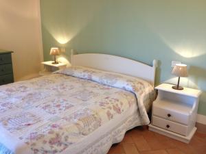 a bedroom with a bed and two night stands at Fattoria Abbazia Monte Oliveto in San Gimignano
