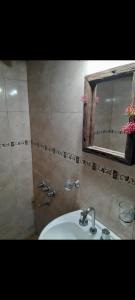 a bathroom with a sink and a mirror at El Arte-Sano in Tandil
