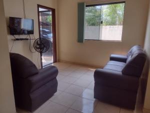a living room with two couches and a television at Casa em Praia de Alter do Chão in Santarém