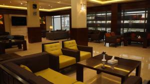 a lobby with couches and chairs and a table at Hmaasat Intour Hotel فندق همسات انتور in Jazan +73 photos