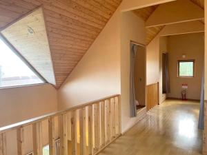 an attic hallway with a skylight and wooden stairs at Cottage with views of the Niseko mountain range - Mountain View Niseko in Niseko +15 photos