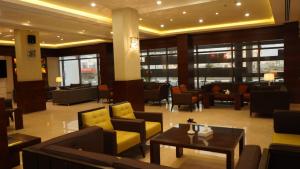 a lobby with couches and chairs and a table at Hmaasat Intour Hotel فندق همسات انتور in Jazan